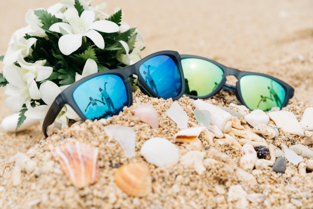 砂浜に置いたサングラスの写真
